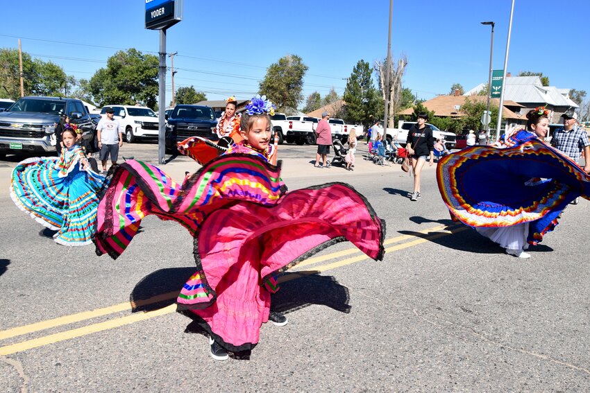 The Orgullo Latino Dancers Folklorico swirling the dresses dancing with music representing Mexico's different regions of culture as they made thier way along Fort Lupton Trapper Days parade route Sept. 9